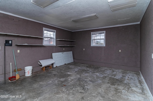 basement featuring crown molding and plenty of natural light