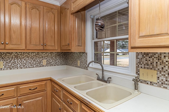 kitchen with tasteful backsplash, sink, and pendant lighting