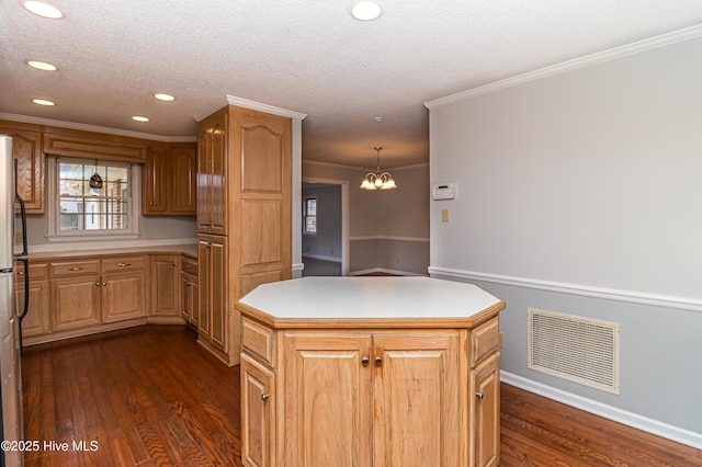 kitchen with hanging light fixtures, dark hardwood / wood-style floors, a textured ceiling, and a kitchen island