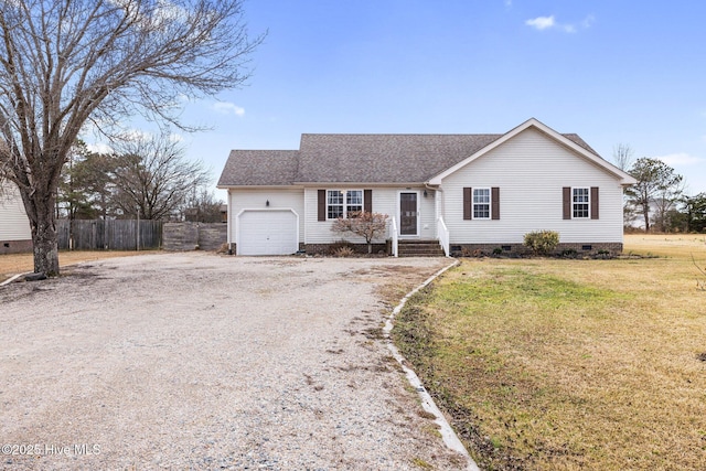 ranch-style home with a garage and a front lawn