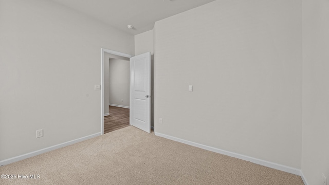 unfurnished bedroom with light colored carpet