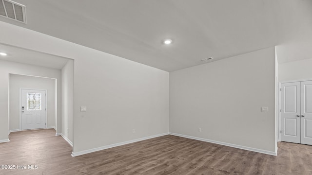 spare room featuring light hardwood / wood-style flooring