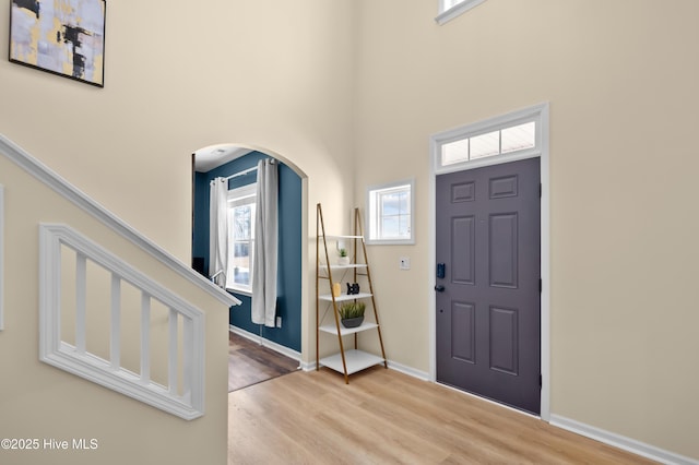 300 William Sharp Way, Jacksonville, NC 28546 - foyer with a high ceiling, arched walkways, healthy amount of natural light, and wood finished floors