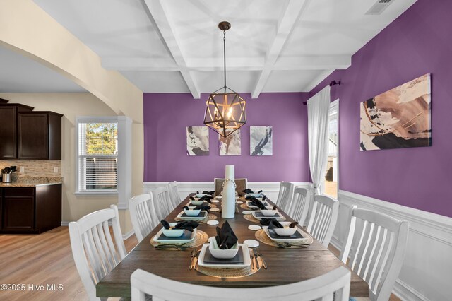 300 William Sharp Way, Jacksonville, NC 28546 - dining room featuring coffered ceiling, wainscoting, beam ceiling, arched walkways, and light wood finished floors