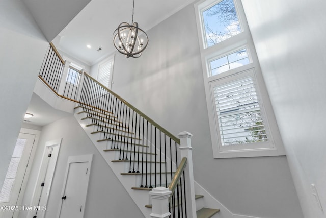 stairs with a healthy amount of sunlight and a high ceiling