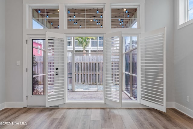 entryway featuring baseboards and wood finished floors