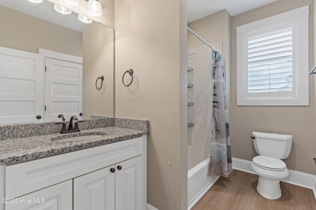 bathroom featuring baseboards, toilet, vanity, and shower / bath combination with curtain