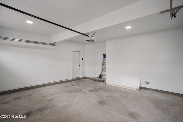 garage with a garage door opener and baseboards