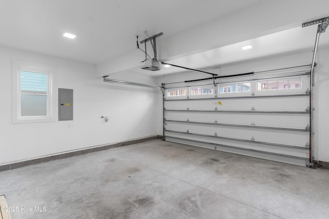 garage with electric panel, a garage door opener, and baseboards