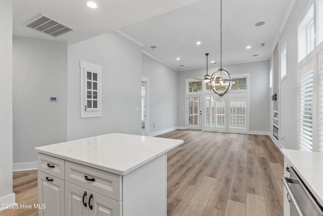 kitchen featuring visible vents, crown molding, baseboards, recessed lighting, and light wood-style floors