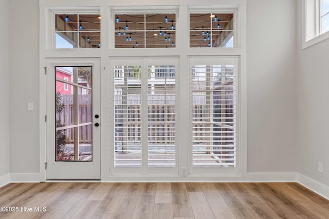 entryway featuring baseboards and wood finished floors