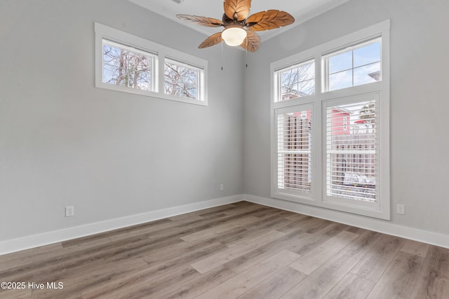 spare room with ceiling fan, baseboards, and wood finished floors