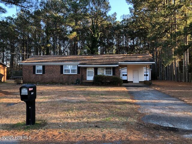 single story home featuring a carport