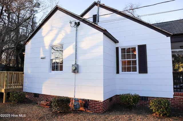 view of side of property with a wooden deck