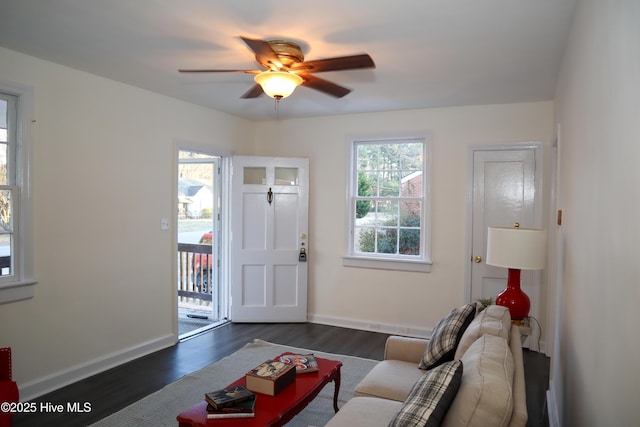 living room with ceiling fan and dark hardwood / wood-style floors