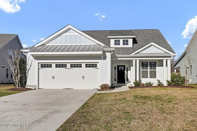 view of front of house featuring a front yard and a garage