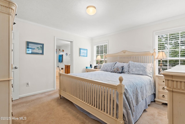 carpeted bedroom with crown molding, a textured ceiling, and ensuite bath