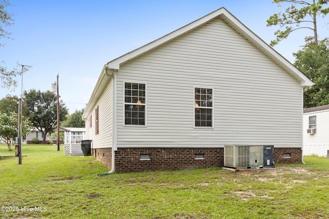 view of home's exterior featuring central AC unit and a lawn