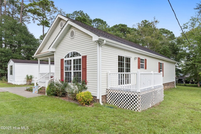 view of home's exterior featuring a lawn and a deck