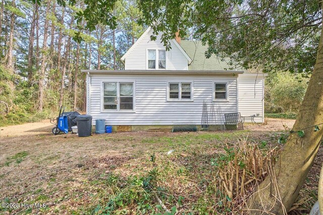 view of side of home featuring a chimney