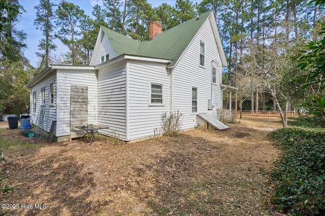 view of property exterior featuring a chimney