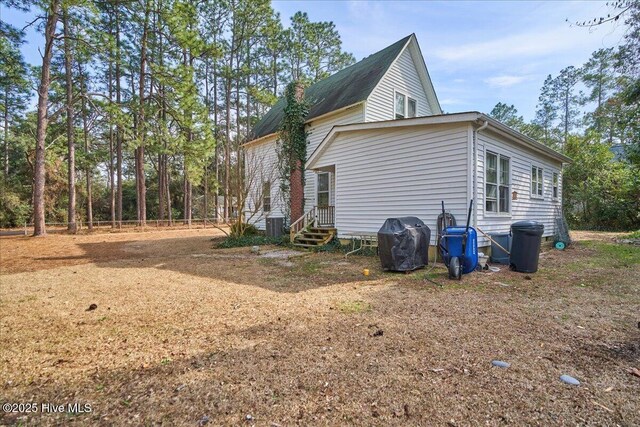 view of side of property featuring entry steps