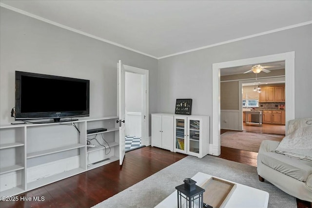 living room featuring crown molding, ceiling fan, and wood finished floors