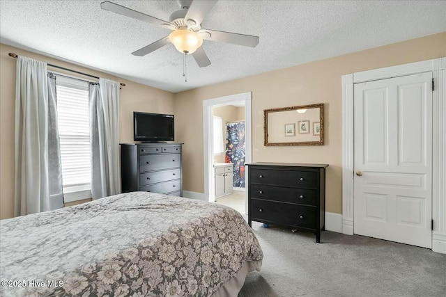 bedroom with a ceiling fan, baseboards, a textured ceiling, and light colored carpet