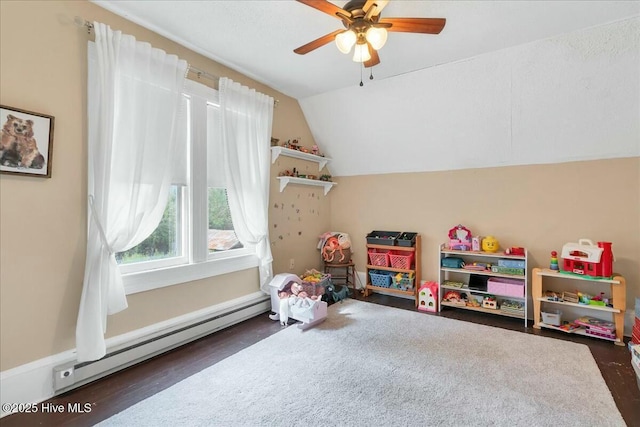 recreation room with vaulted ceiling, baseboard heating, and ceiling fan