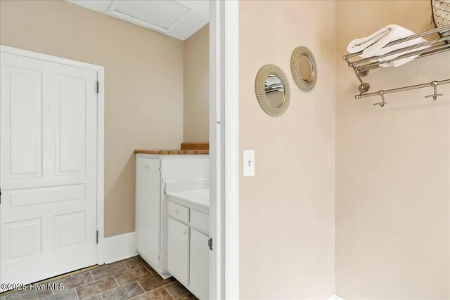 bathroom with stone finish flooring and vanity