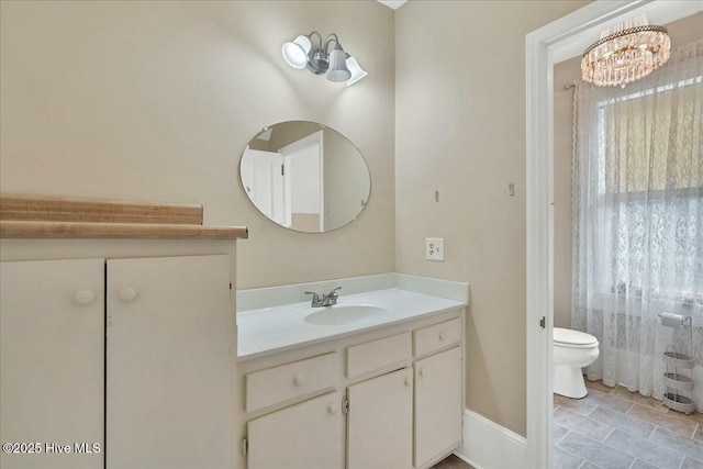 bathroom featuring vanity and toilet