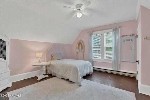 bedroom with lofted ceiling, baseboard heating, wood finished floors, and baseboards