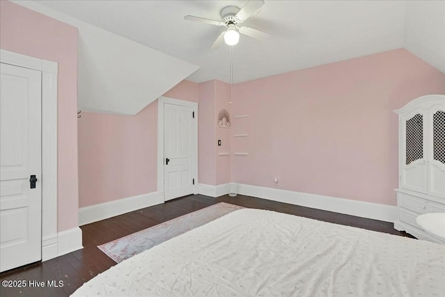 bedroom featuring vaulted ceiling, wood finished floors, a ceiling fan, and baseboards