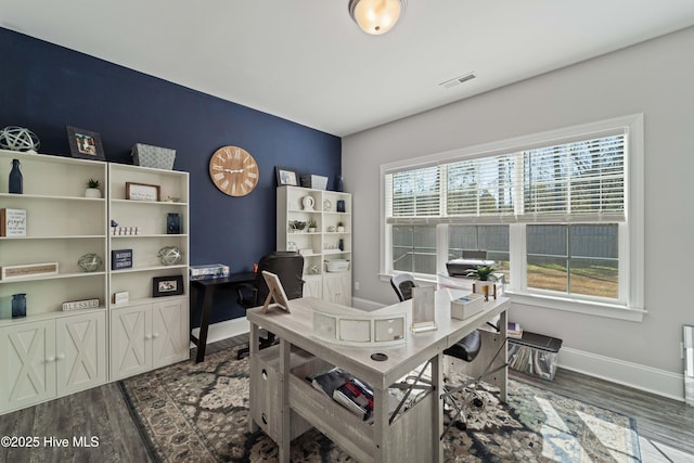 home office with dark hardwood / wood-style flooring