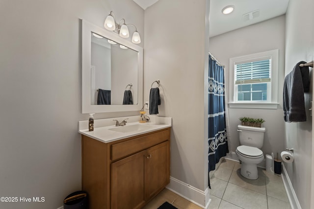 bathroom with vanity, tile patterned floors, and toilet