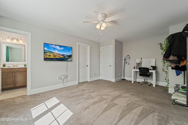 unfurnished bedroom featuring connected bathroom, light colored carpet, and ceiling fan