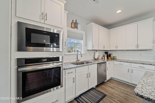 kitchen with white cabinetry and appliances with stainless steel finishes