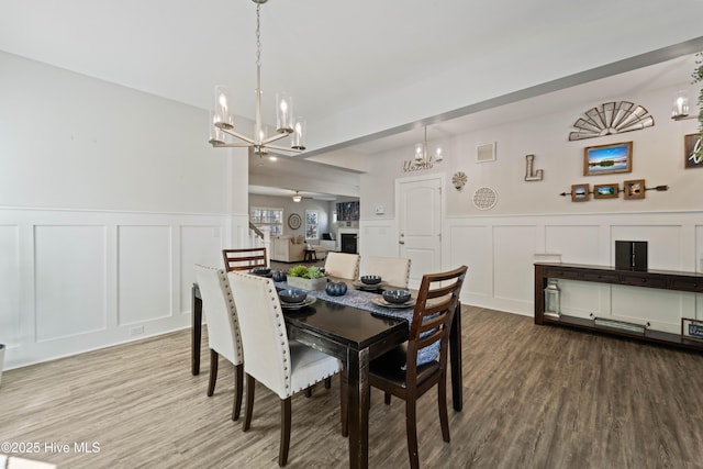 dining area featuring light hardwood / wood-style floors and a chandelier