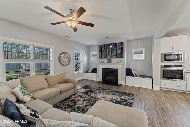 living room featuring hardwood / wood-style floors and ceiling fan