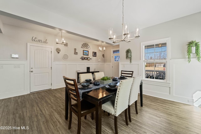 dining area featuring an inviting chandelier and wood-type flooring