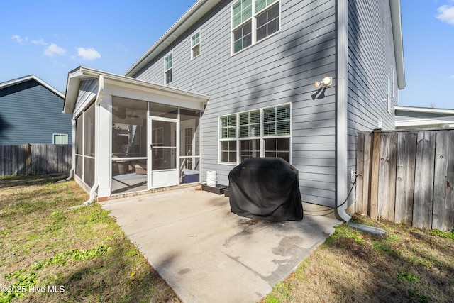 rear view of property featuring a yard, a patio area, and a sunroom