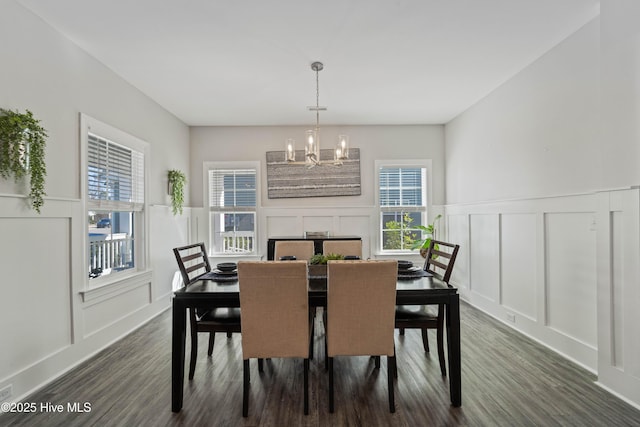 dining area with dark hardwood / wood-style floors and a chandelier