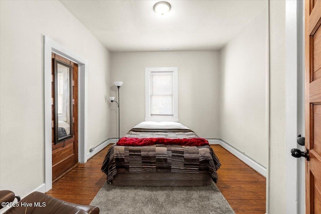 bedroom with wood-type flooring