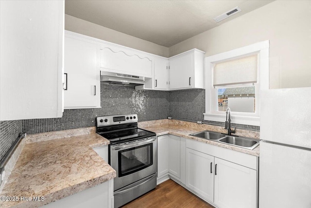 kitchen featuring sink, electric range, ventilation hood, white cabinets, and white fridge