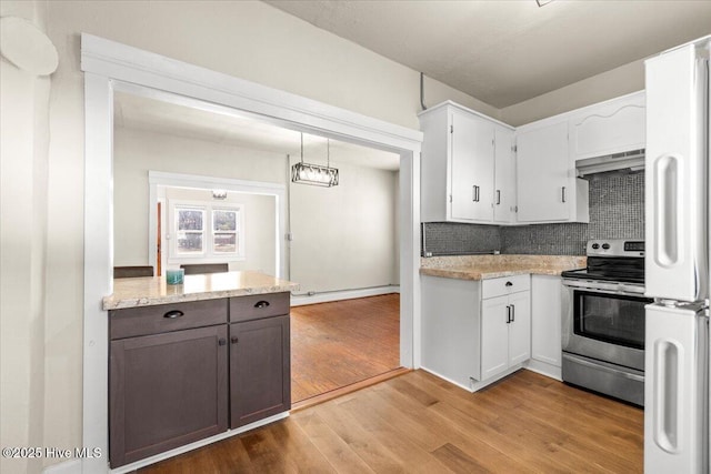 kitchen with white cabinetry, electric range, ventilation hood, decorative backsplash, and decorative light fixtures