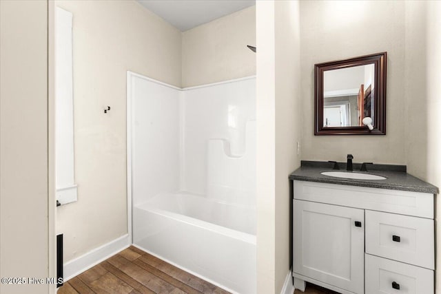 bathroom with shower / tub combination, wood-type flooring, and vanity