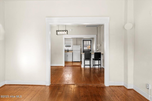 unfurnished dining area featuring dark wood-type flooring