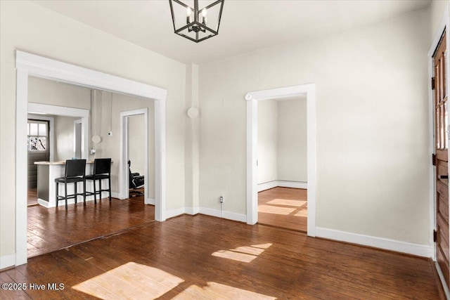 interior space featuring an inviting chandelier and dark hardwood / wood-style flooring