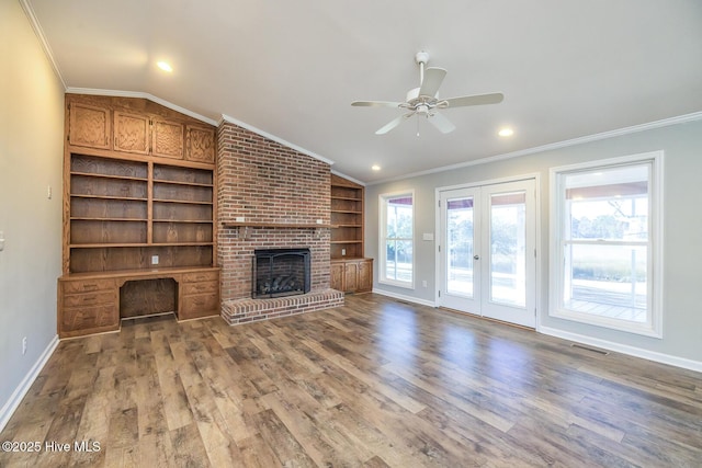 unfurnished living room featuring lofted ceiling, hardwood / wood-style flooring, and ornamental molding