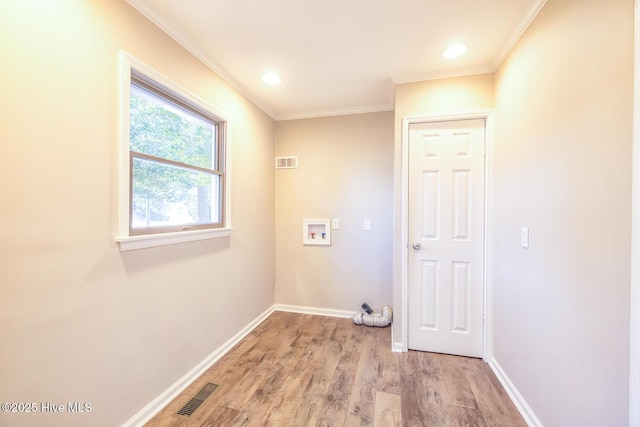 washroom with washer hookup, crown molding, and light hardwood / wood-style floors